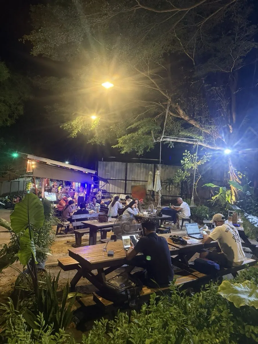 Garden tables in the evening at Samed Coco Bar